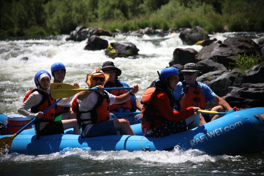 A family celebrates a successful run through Dragon's Tooth Rapid on the Lower Klamath.